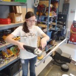 Hannah polishing a metal frame.